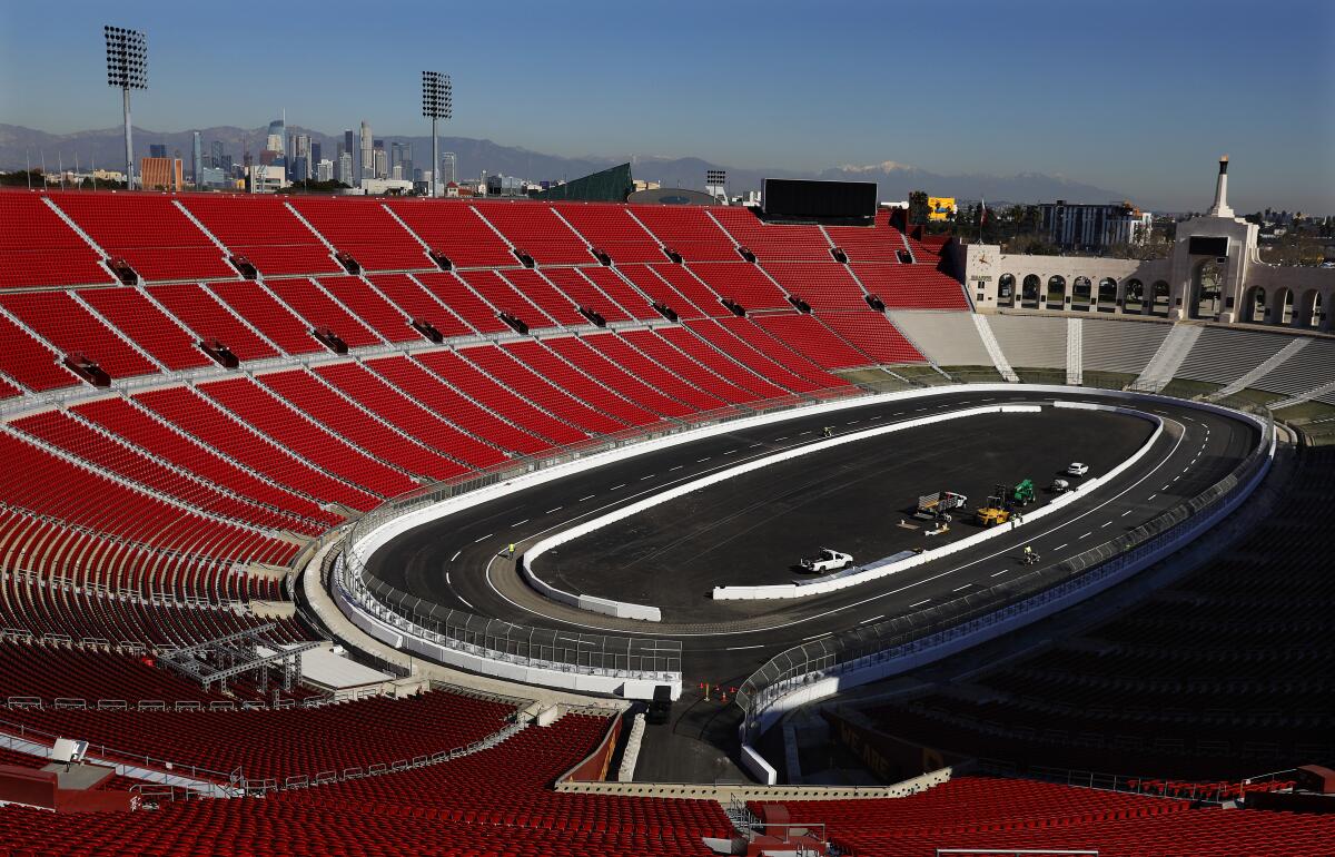 Lane lines are painted ahead of the NASCAR race at the L.A. Memorial Coliseum in 2022.
