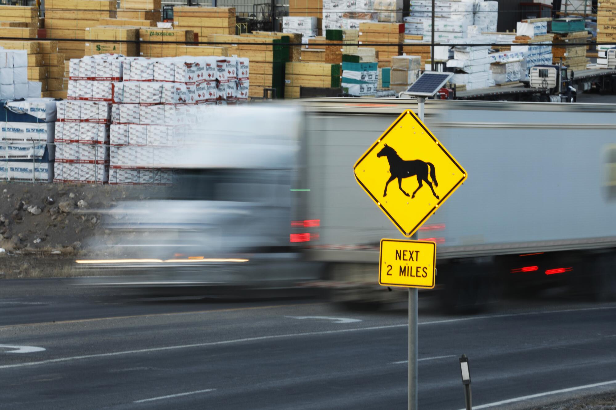 A sign warns of horses: "Next 2 miles."
