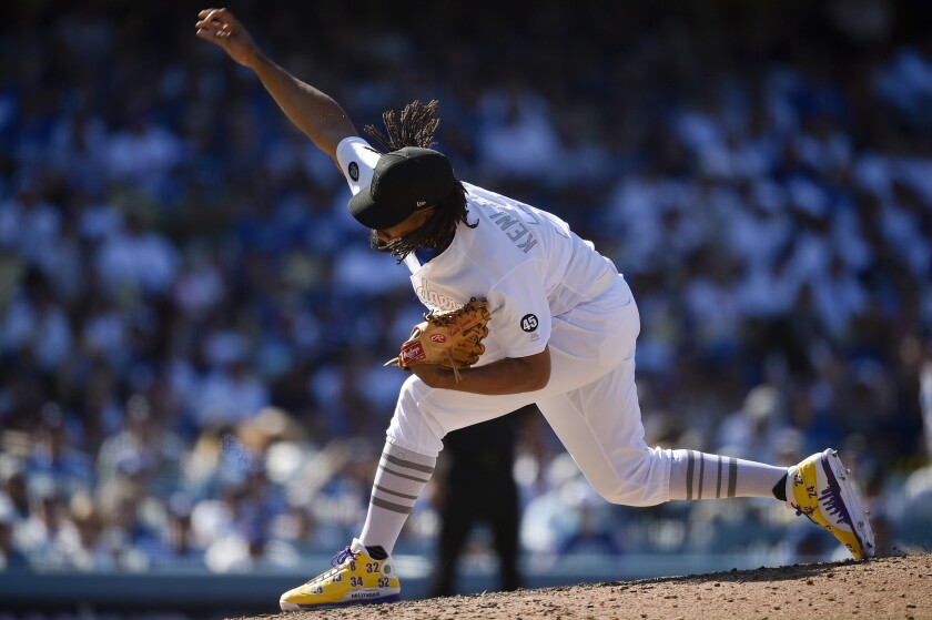 Kenley Jansen delivers during the ninth inning of the Dodgers' 2-1 victory over the New York Yankees on Saturday.