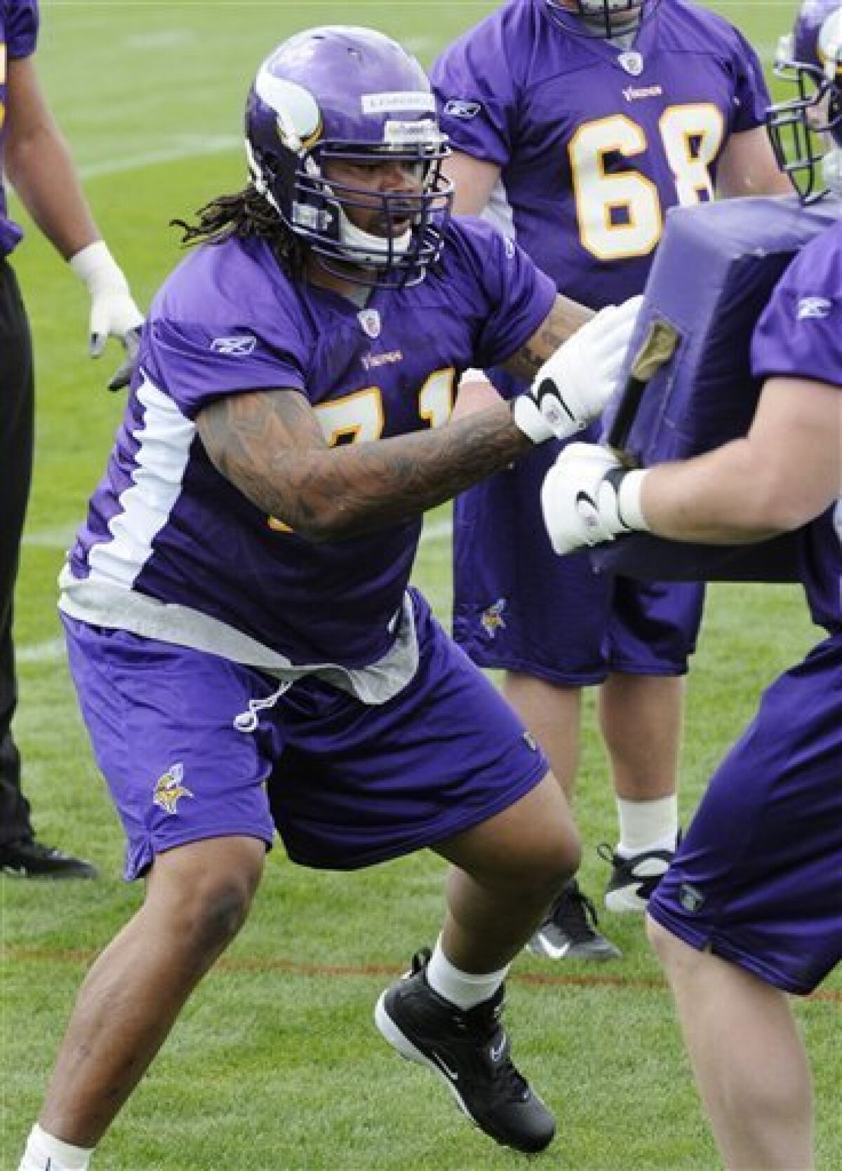 Minnesota Vikings tackle Phil Loadholt, left, a second-round draft pick, goes through drills during the Vikings' minicamp Friday, May 1, 2009, in Eden Prairie, Minn. (AP Photo/Jim Mone)