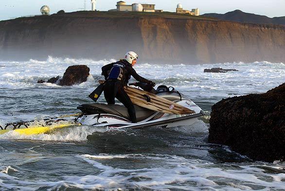 January 2003: Shawn Alladio speeds away from an oncoming set at Maverick's in the Monterey Bay National Marine Sanctuary after crashing into a rock that was hidden by the wave.
