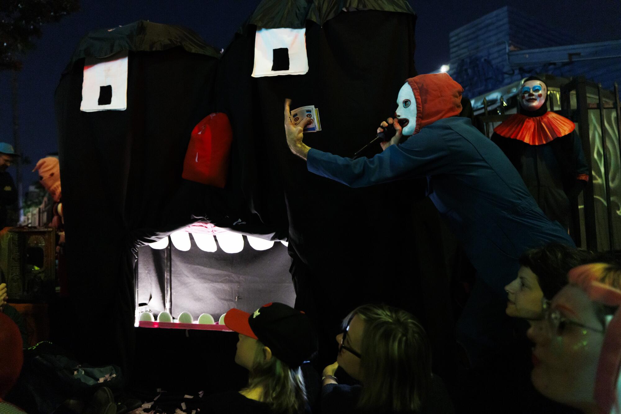 Jeffrey's Human Persona wears a white mask and red hoodie.