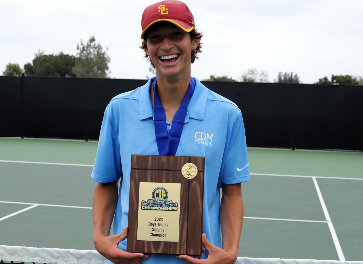 Corona del Mar High's Niels Hoffmann smiles as he holds the CIF championship plaque.