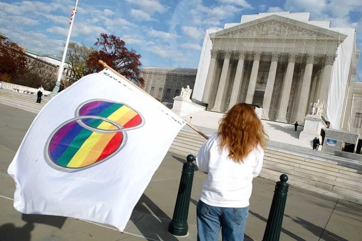 Gay-rights demonstrators stand in front of the U.S. Supreme Court building in 2012.