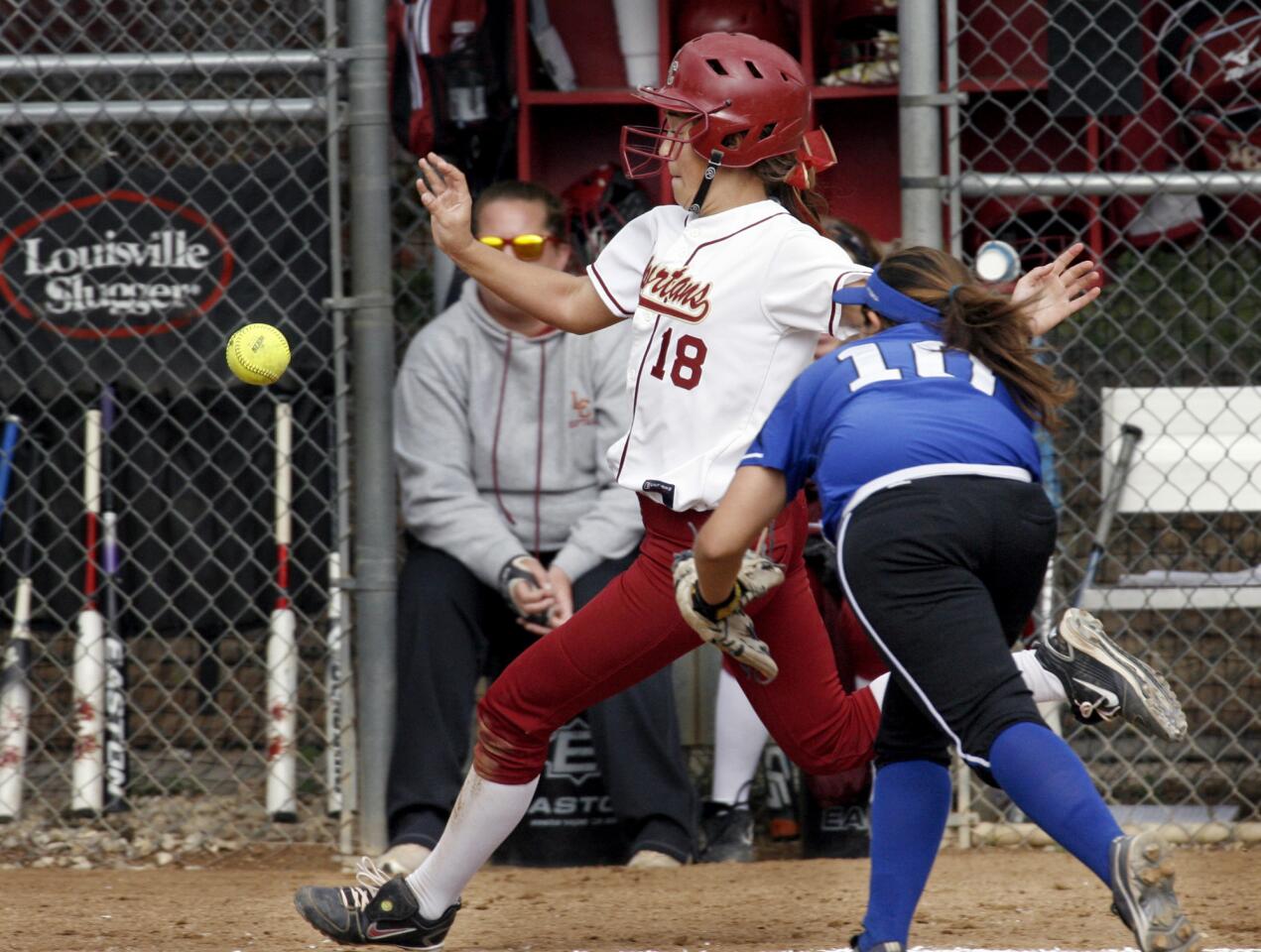 La Canada's Annie Monroe races the ball to home plate to score the first run of the game as San Marino's Jackie Martinez moves in on Thursday, May 3, 2012.