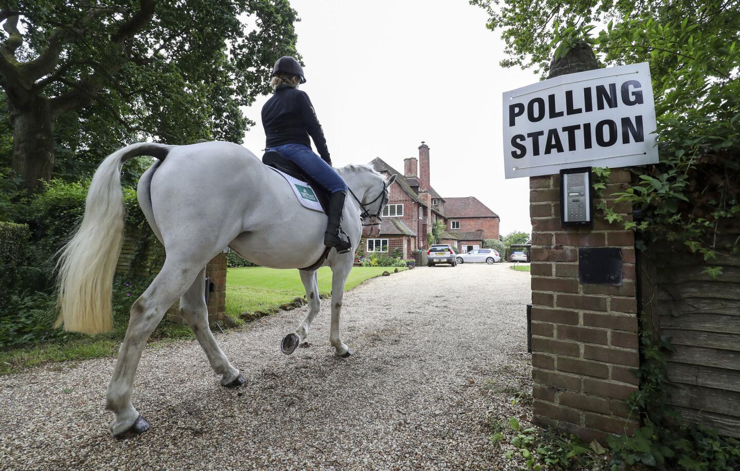 Sophie Allison returns to the stables on her horse Splash at the private residence Three Oaks in Bramshill, which is being used a polling station in Hampshire, England, on June 8, 2017.