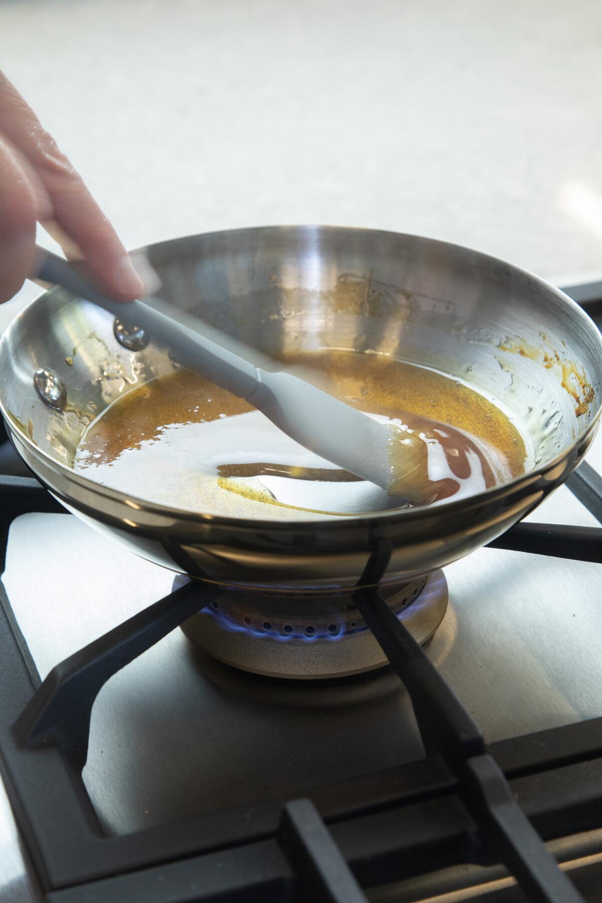 Caramelizing sugar over a gas burner.