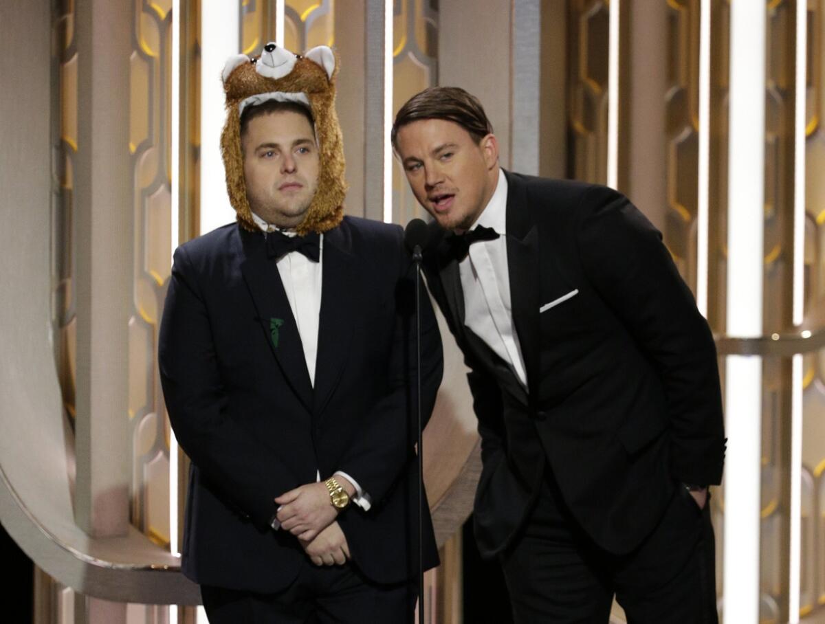 Jonah Hill, left, joined Channing Tatum to present an award at the 73rd Annual Golden Globe Awards on Sunday. He also dressed as the bear from "The Revenat."