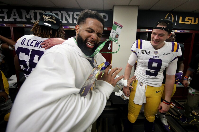 Odell Beckham Jr. celebrates in the Louisiana State locker room with quarterback Joe Burrow after their 42-25 win over Clemson in the College Football Playoff National Championship game at Mercedes Benz Superdome.