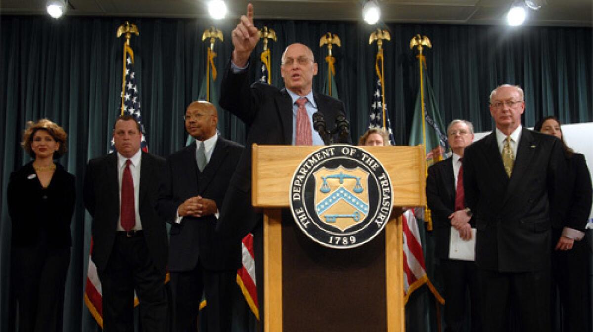REACHING OUT: Treasury Secretary Henry Paulson, center, announces an initiative in which a group of lenders would help borrowers stave off foreclosure.