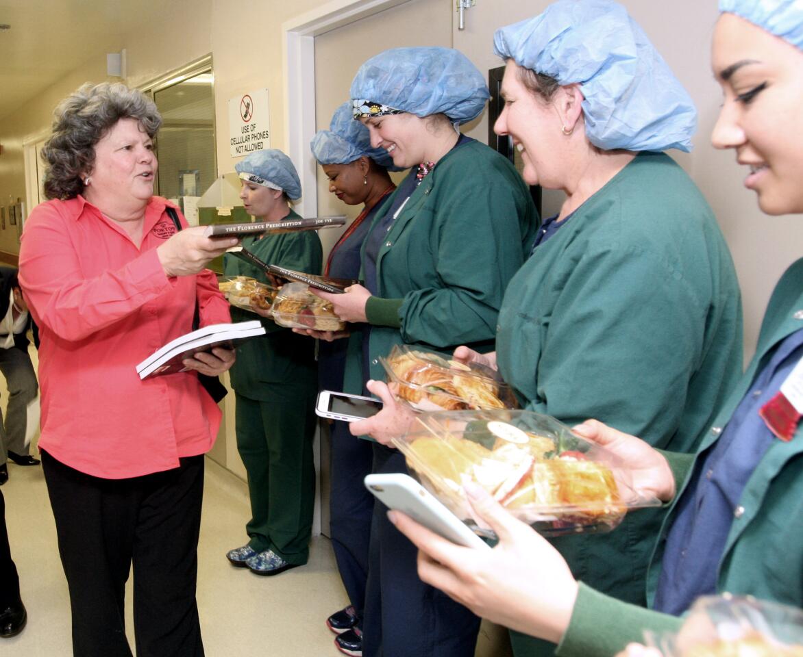 Betty Porto of Porto's Bakery passes out books to nurses after they received lunch from Porto's for Nurses Week, at USC Verdugo Hills Medical Center in Glendale on Tuesday,May 10, 2016. Two hundred lunches were made possible by a generous donation from foundation member Bill Pounders.