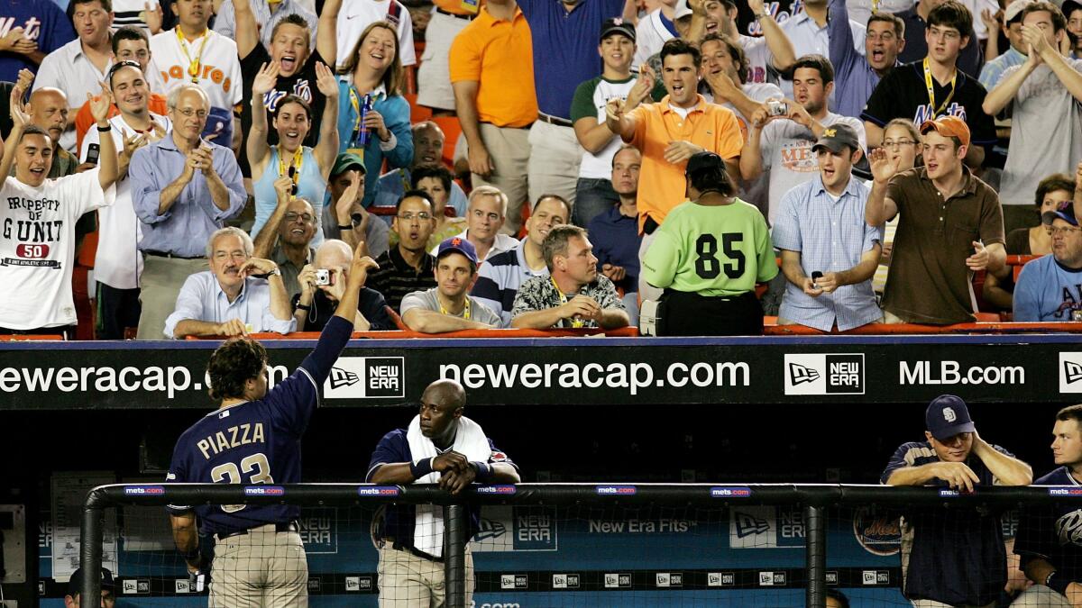 Mike Piazza of the San Diego Padres looks on as he stands outside the