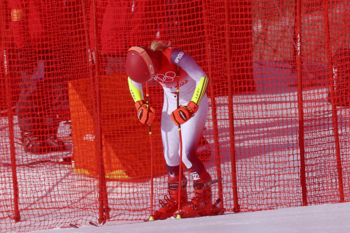 Mikaela Shiffrin of United States looks down after skiing off course during the first run of the women's giant slalom at the 2022 Winter Olympics, Monday, Feb. 7, 2022, in the Yanqing district of Beijing. (AP Photo/Alessandro Trovati)