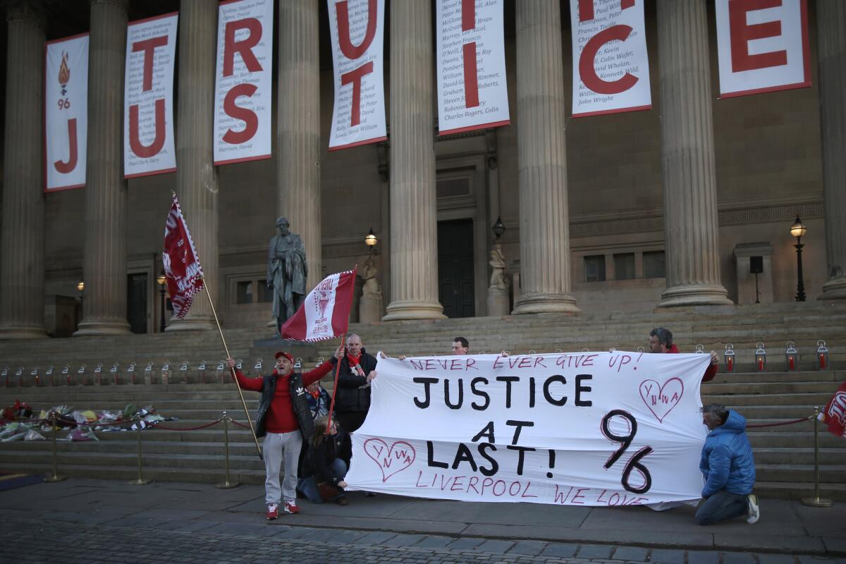 A banner reading "Truth and Justice" is hung from the pillars of Saint George's Hall in Liverpool, Britain, on April 26, after the jury rendered a verdict in the 1989 Hillsborough soccer disaster.