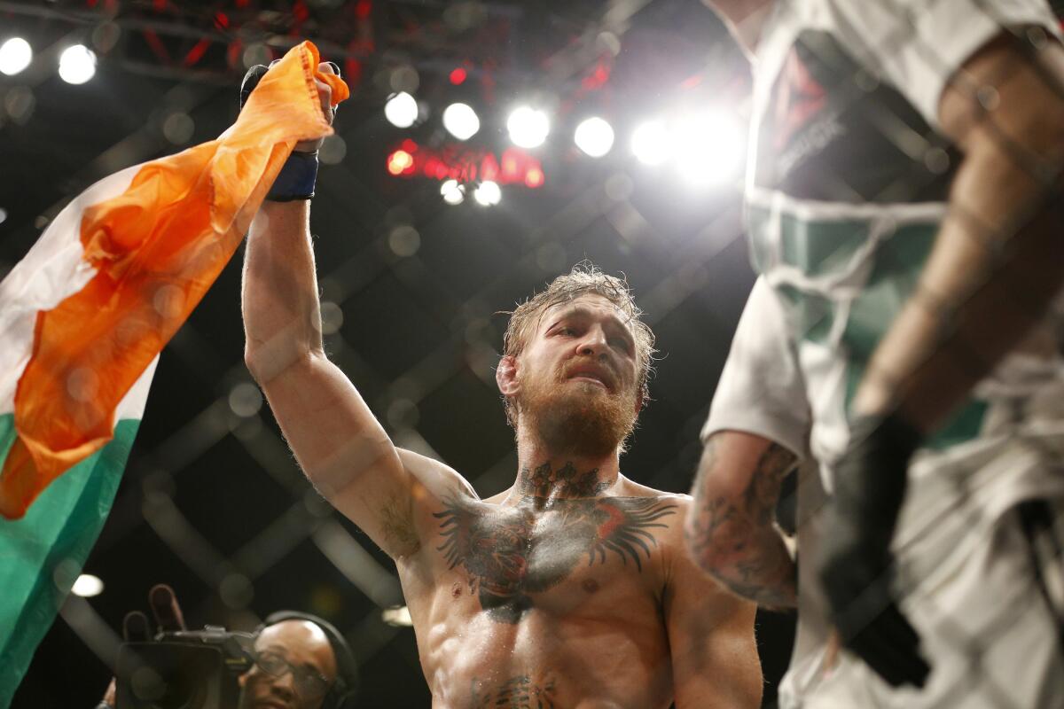 Conor McGregor celebrates after defeating Chad Mendes in their interim featherweight title fight at UFC 189 on Saturday in Las Vegas.