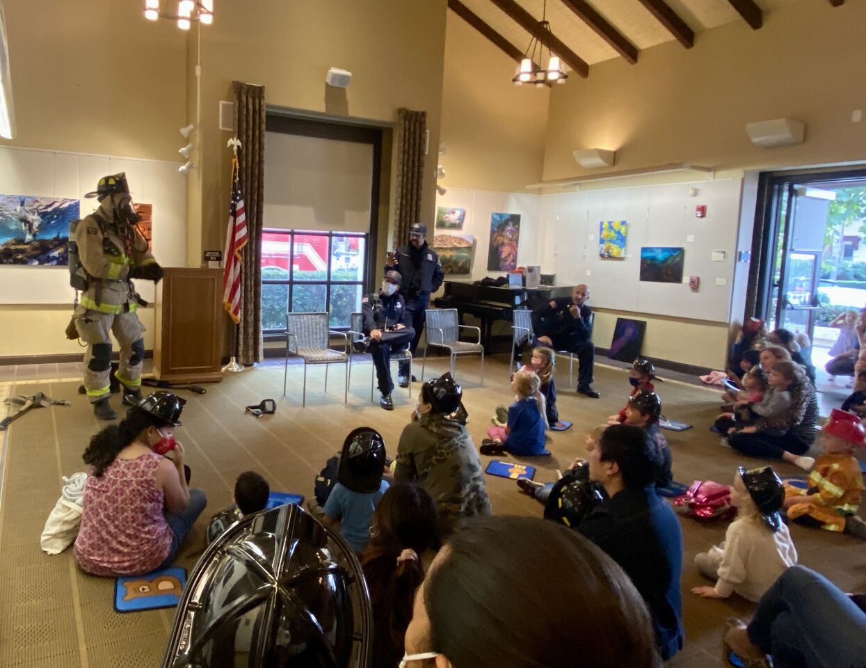 A La Jolla firefighter shows his protective gear to a crowd at the La Jolla/Riford Library on Nov. 4.