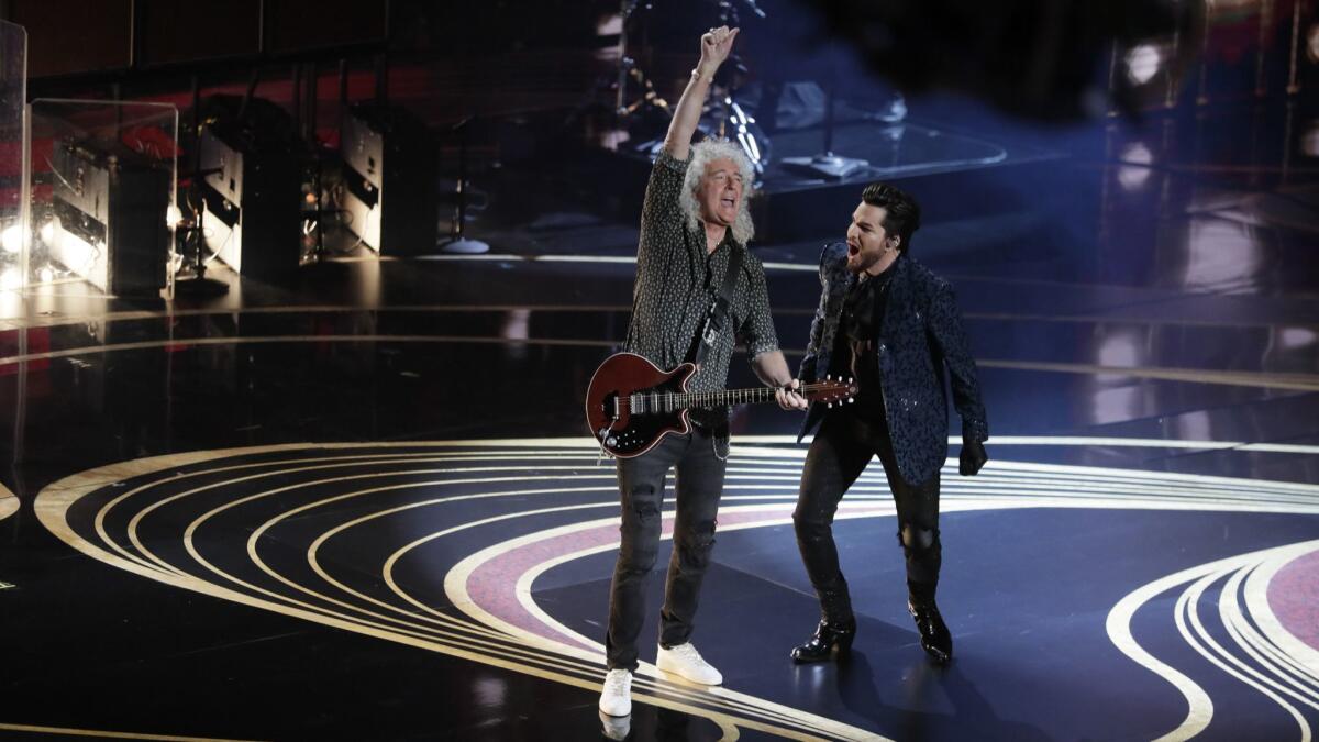 Queen guitarist Brian May performs with Adam Lambert.