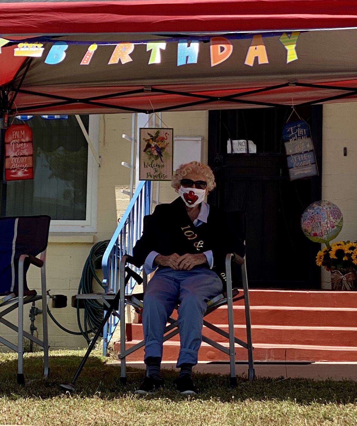 Ruby Minder watches a parade of well-wishers pass her house in honor of her 100th birthday May 15.