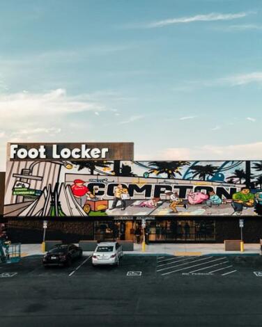 A photograph of a mural painted on the Foot Locker building in Compton.