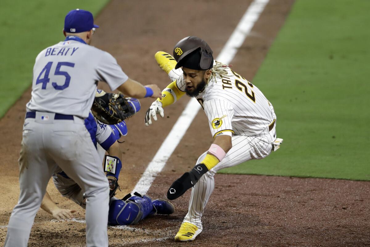 San Diego Padres' Fernando Tatis Jr. is tagged out by Dodgers catcher Will Smith during the seventh inning.