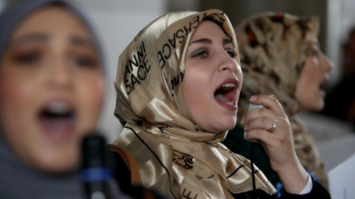 Women protest President Trump's immigration ban during a rally at LAX's Tom Bradley International Terminal on Saturday.