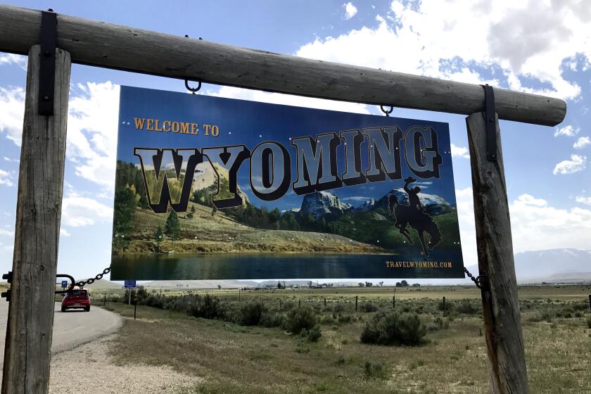 FILE - A sign on the border of Wyoming and Montana appears on the side of Belfry Highway, May 24, 2017, in Powell, Wyo. President Joe Biden will face Democratic voters this Saturday, April 13, 2024, in a pair of nominating contests in Alaska and Wyoming that are unlikely to produce any surprises. In Wyoming, Democrats will award 13 delegates using a presidential preference vote held at 23 county-level caucuses. (AP Photo/Robert Yoon, File)