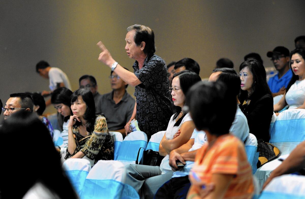 Larry Nguyen, a nail salon owner, makes a point during a community forum in Little Saigon.