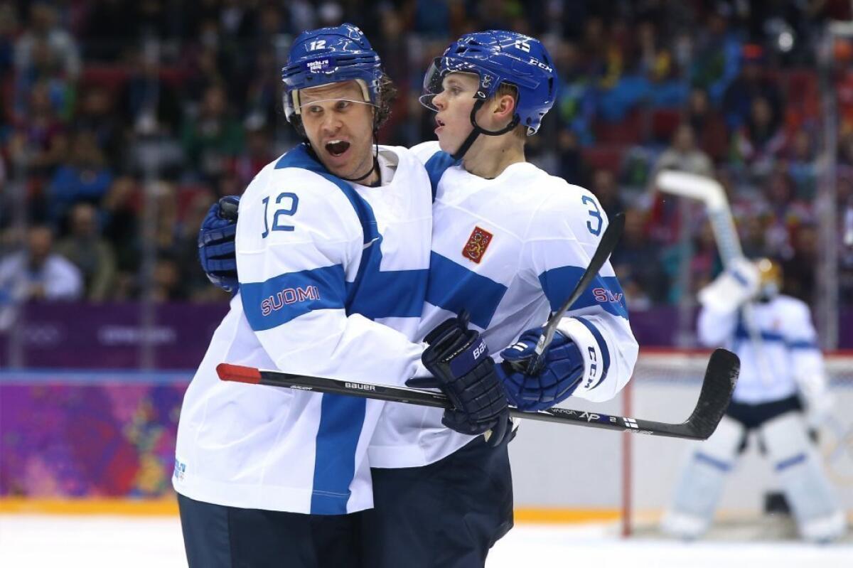 Olli Maatta, right, of Finland celebrates with teammate Olli Jokinen after scoring a goal in the first period against Austria.