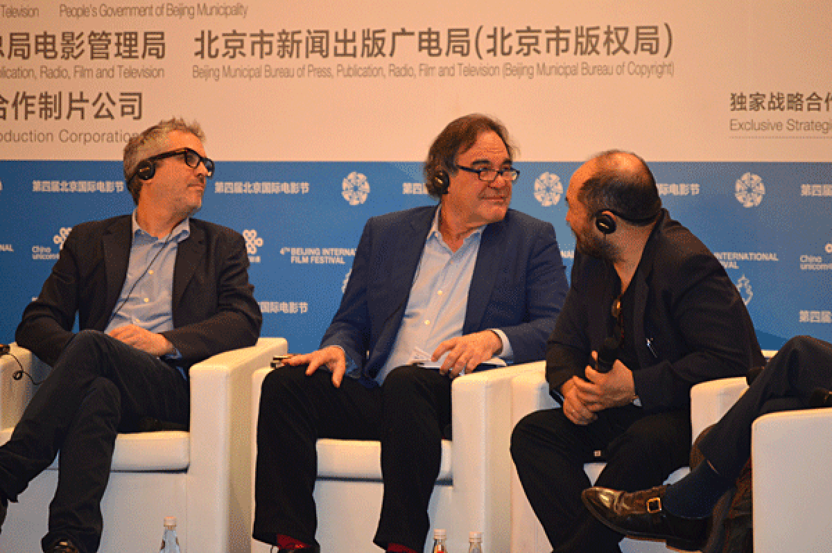 From left, Alfonso Cuaron, Oliver Stone and Timur Bekmambetov at a panel discussion at the Beijing Film Festival.