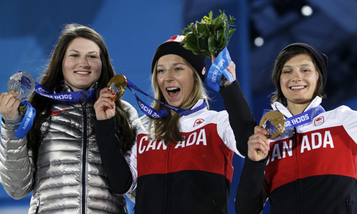American silver medalist Devin Logan, left, Canadian gold medalist Dara Howell, center, and Canadian broze medal-winner Kim Lamarre celebrate their podium finishes in women's slopestyle skiing at the Sochi Winter Olympics on Tuesday.