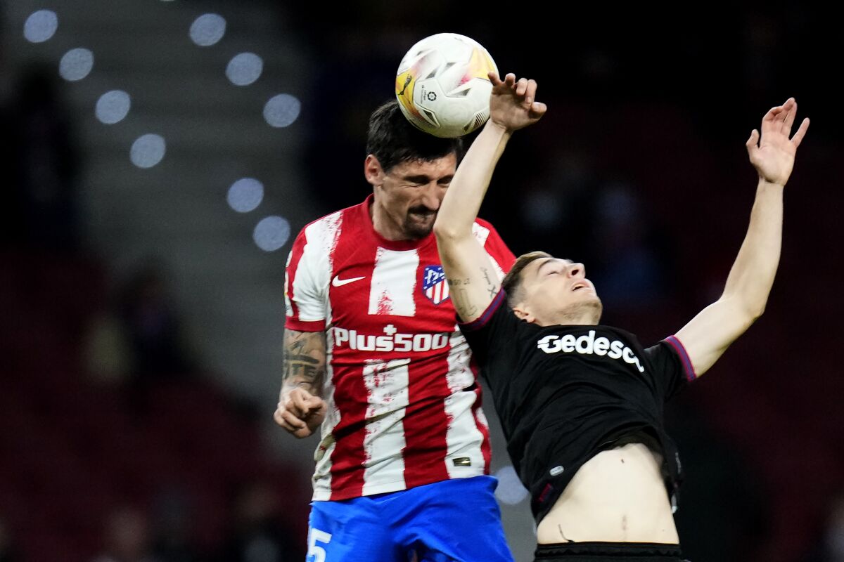 Atletico Madrid's Stefan Savic, left, and Levante's Jorge de Frutos jump for the ball during a Spanish La Liga soccer match between Atletico Madrid and Levante at the Wanda Metropolitano stadium in Madrid, Spain, Wednesday, Feb. 16, 2022. (AP Photo/Manu Fernandez)