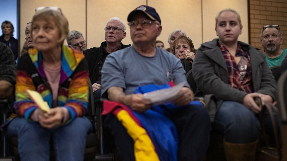 Camp fire evacuees wait to hear when they will be allowed back into Paradise to retrieve items from their burned properties during a town meeting at the Chico City Hall.