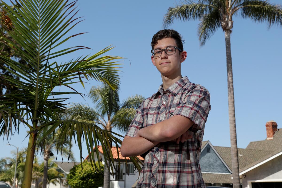 Huntington Beach High School junior Colin Parrott, 16, poses for a portrait in his neighborhood on Wednesday. 