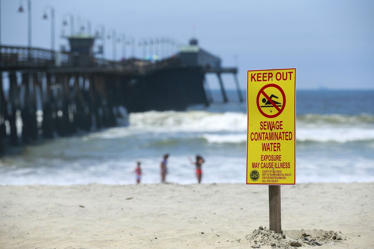 Signs warn of contaminated ocean water in Imperial Beach on May 30. 