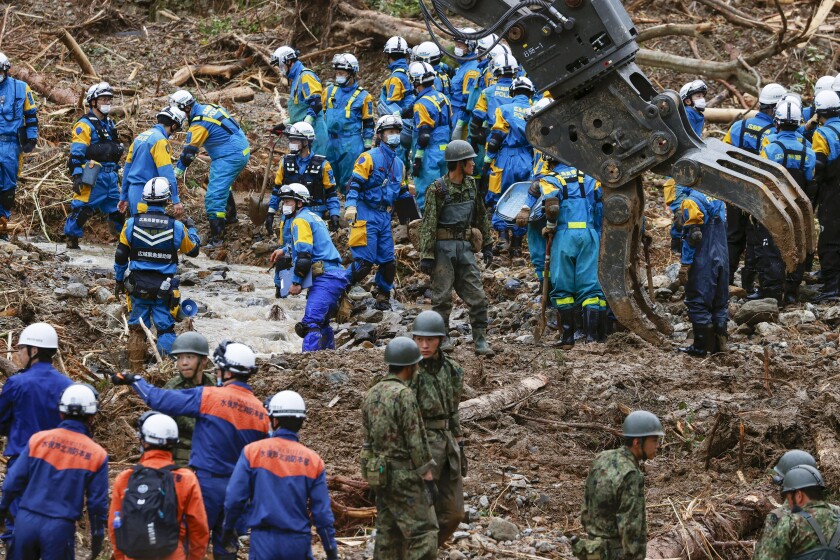Rescuers search for missing persons at the site of a landslide in Tsunagi town, Kumamoto prefecture, southern Japan Monday, July 6, 2020. Rescue operations continued and rain threatened wider areas of the main island of Kyushu. (Takuto Kaneko/Kyodo News via AP)