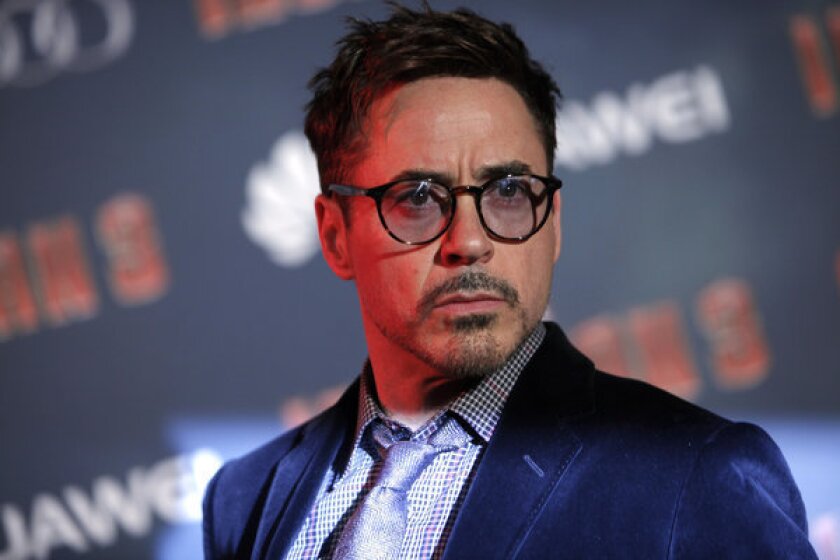 Actor Robert Downey Jr. poses for photographers during the "Iron Man 3" premiere in Paris on April 14.