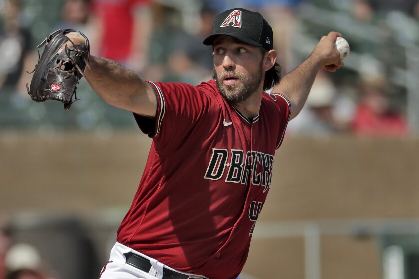 FILE - In this Feb. 27, 2020, file photo, Arizona Diamondbacks pitcher Madison Bumgarner throws during the second inning of spring training baseball game against the Cincinnati Reds in Scottsdale Ariz. Arizona's new pitching addition Bumgarner threw two innings of live batting practice on Saturday, July 4, 2020. It was his first outing during the team's summer camp at Chase Field as the D-backs prepare for a 60-game season. (AP Photo/Matt York, File)