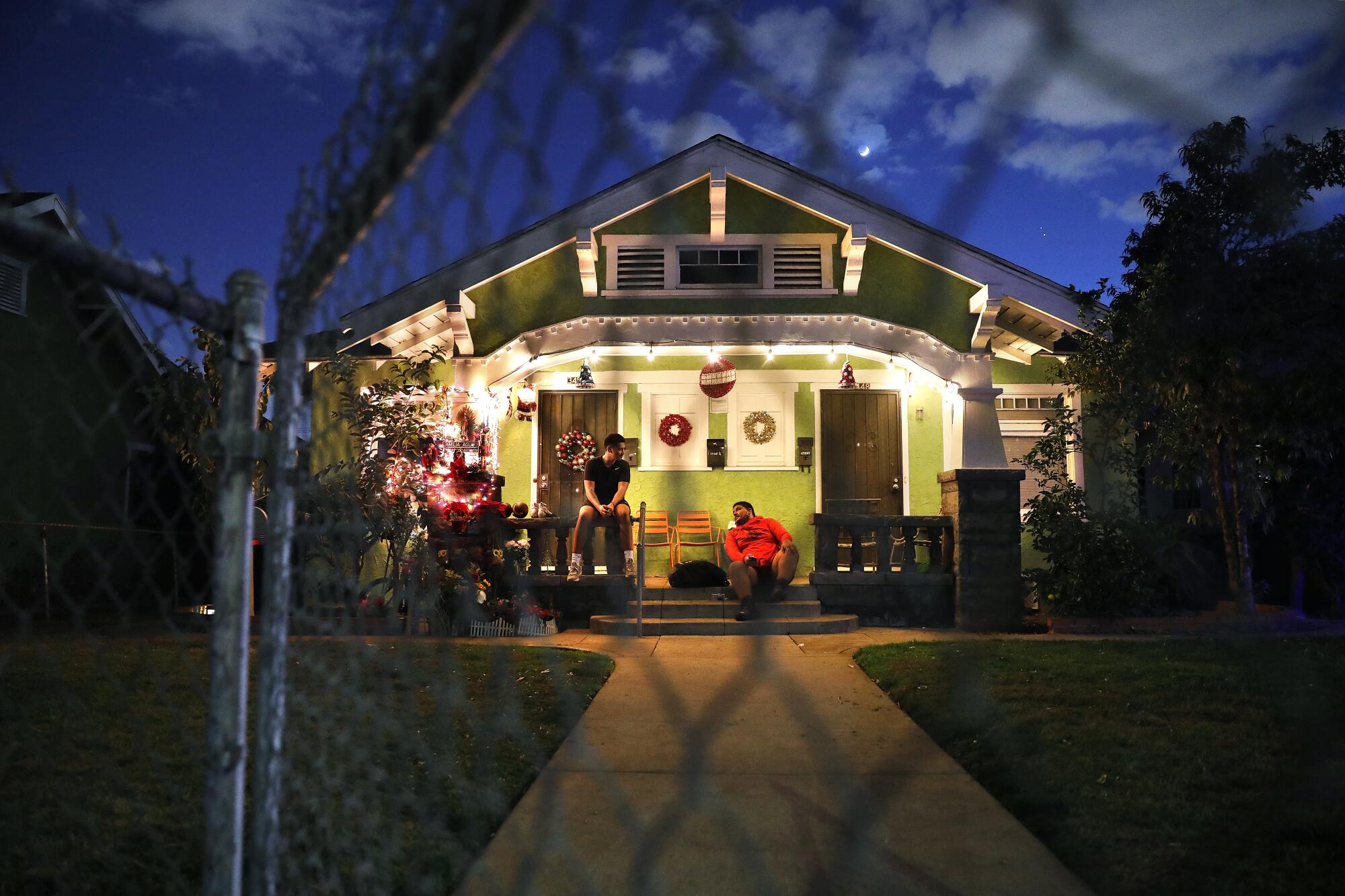 East L.A. Roosevelt players Damian Avalos, left, and Benjamin Reyes sit on the steps of Avalos' home.