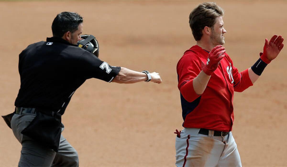 Washington outfielder Bryce Harper is called out at third Sunday against the Atlanta Braves in Lake Buena Vista, Fla.