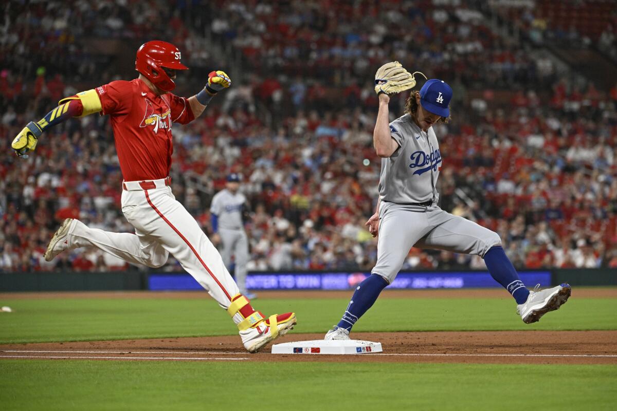 Dodgers pitcher Justin Wrobleski forces out St. Louis batter Lars Nootbaar at first base.