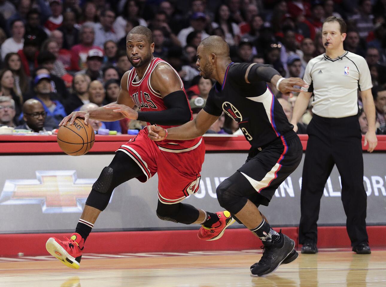 Clippers point gurad Chris Paul tries to cut off a drive by Bulls guard Dwyane Wade during the second half Saturday.