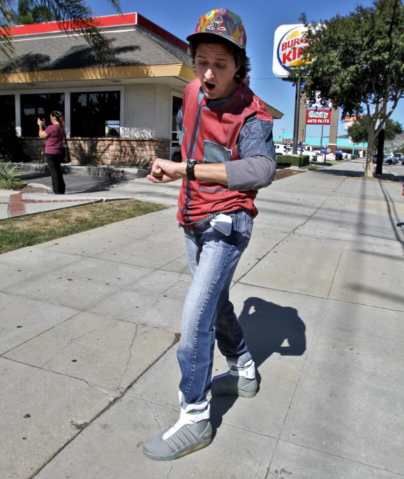 Marty Theis, 53 of Glendale, strikes a pose as Back To The Future's Marty McFly, in front of the Burger King on Victory Blvd. in Burbank on Tuesday, October 21, 2015. In the movie, McFly is seen holding on to the back of a pick-up truck while riding a skateboard. McFly also arrives in the future on the specific day, Oct. 21, 2015. A large crowd gathered at this location to celebrate the date.