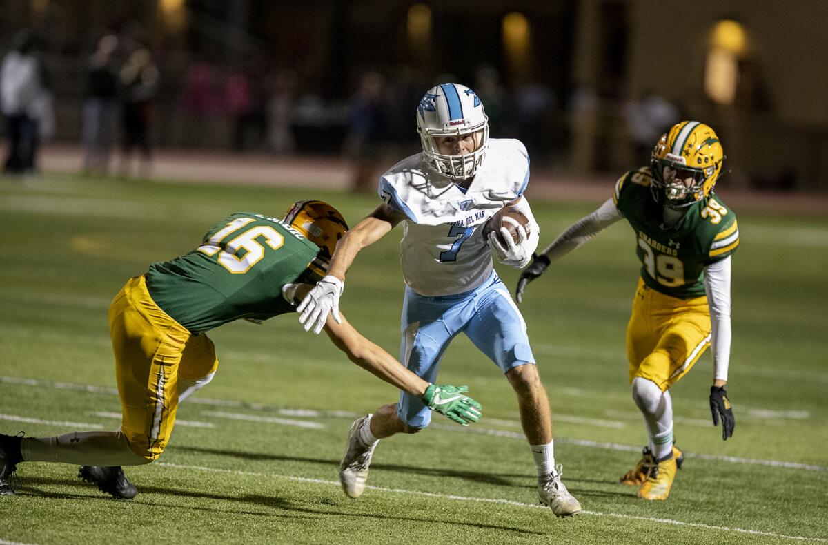 Corona del Mar's John Tipton attempts to avoid a tackle from Edison's Cody Grbic.