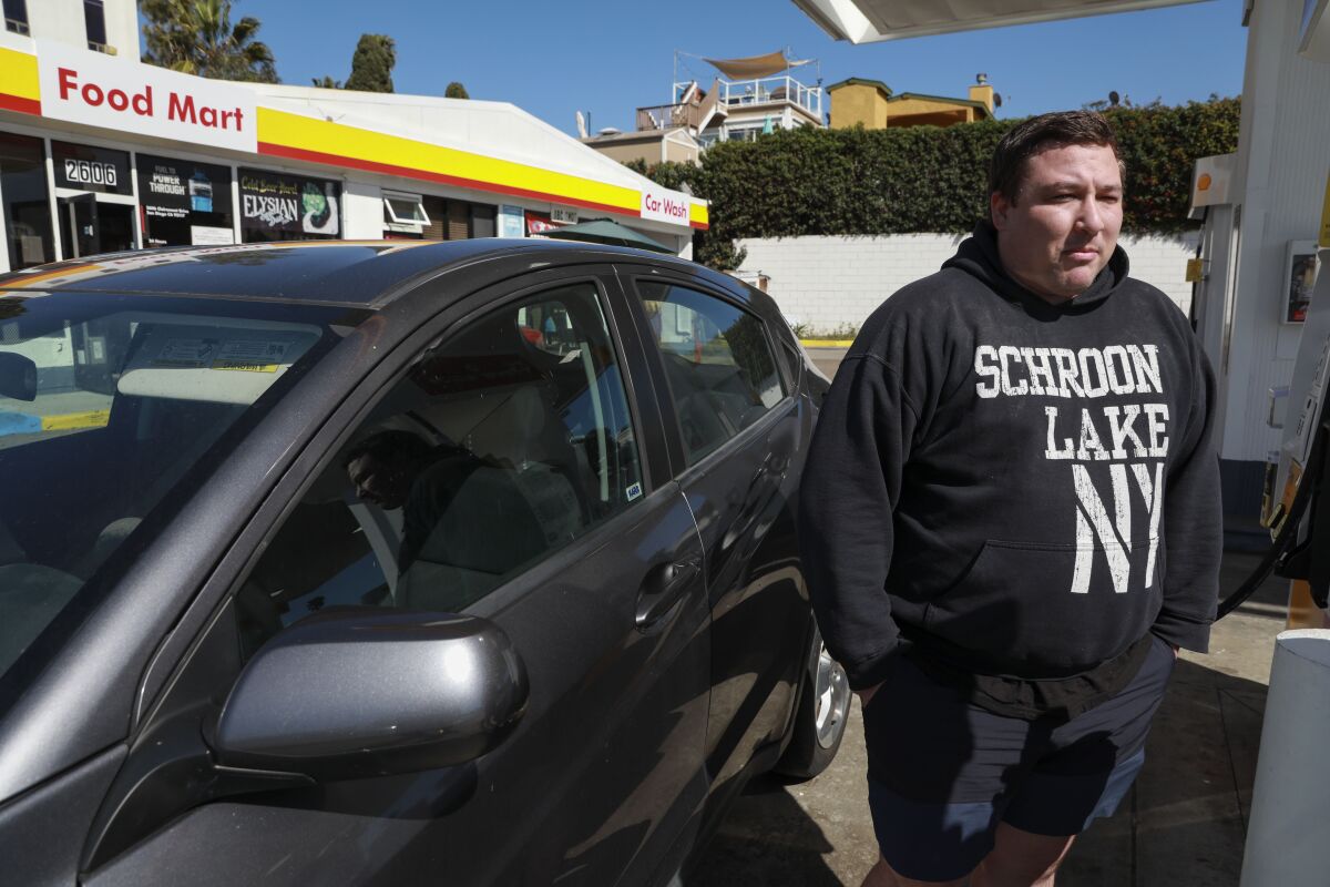 Brett Beuck fills up his gas tank at a Shell Station along Clairemont Drive San Diego