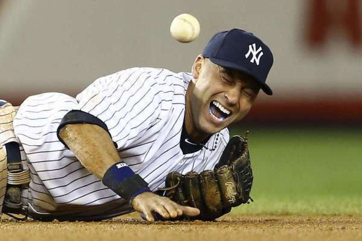 Derek Jeter grimaces in pain after breaking his ankle in Game 1 of the American League Championship Series.