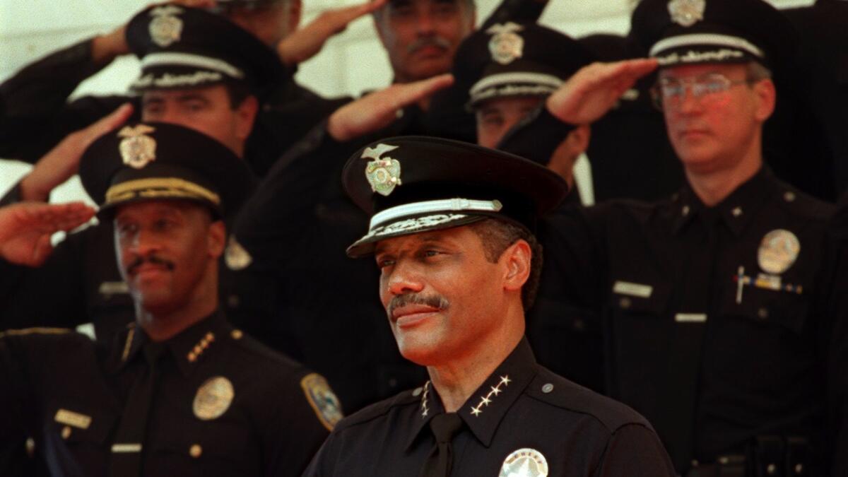 Bernard C. Parks receives a salute from officers as he is formally sworn in as the LAPD's chief in 1997. (Carolyn Cole / Los Angeles Times)