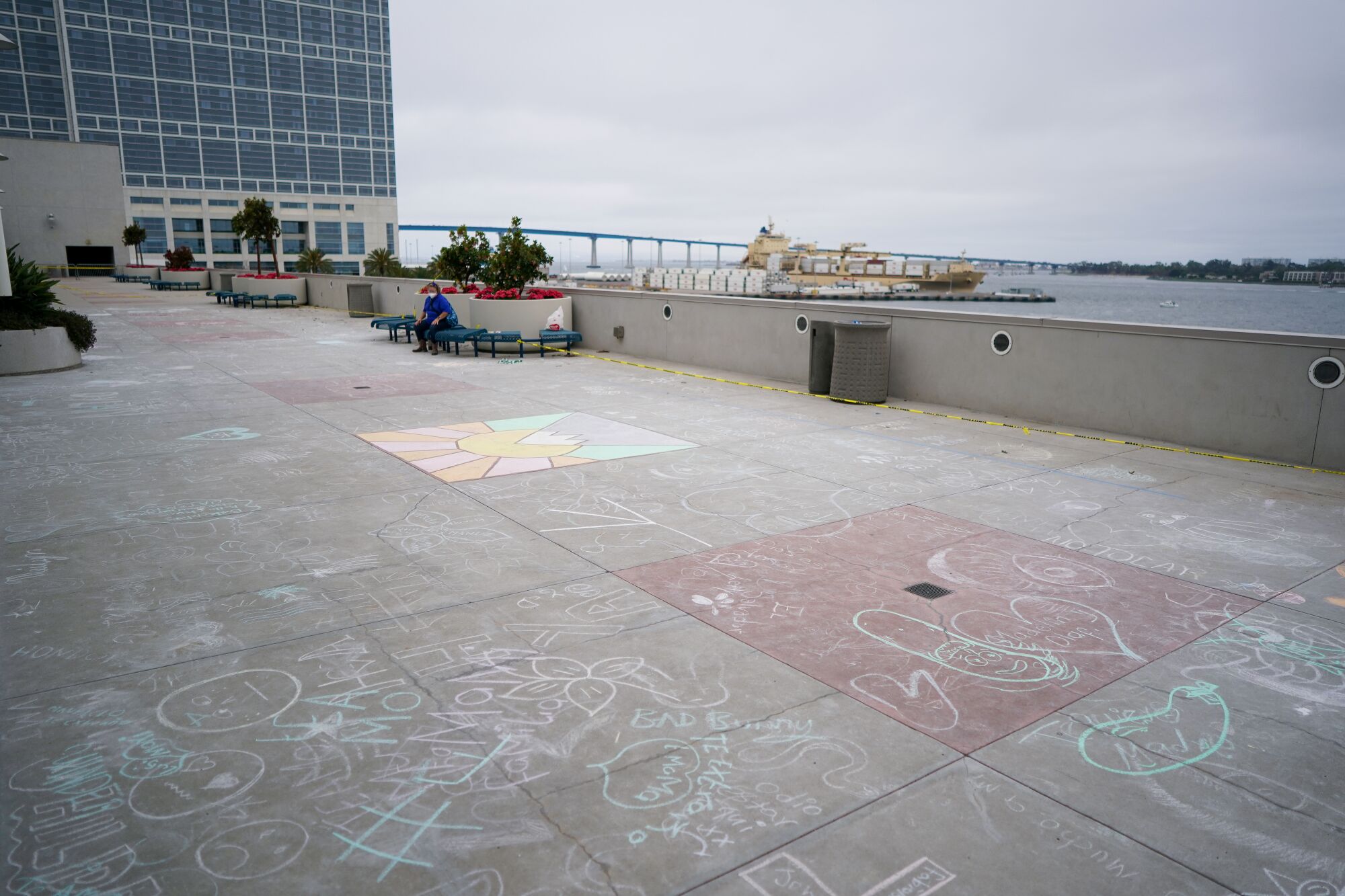 Chalk drawings are scattered on the ground on the terrace outside the upper level of the convention center