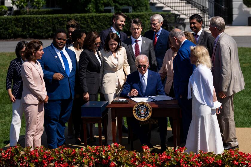 WASHINGTON, DC - AUGUST 09: President Joe Biden signs the CHIPS and Science Act of 2022 into law during an event at the South Lawn of the White House on Tuesday, Aug. 9, 2022 in Washington, DC. US semiconductor firms are announcing billions in investments as President Biden signs the broad competition bill that aims to support domestic semiconductor production, new high-tech jobs and scientific research. (Kent Nishimura / Los Angeles Times)