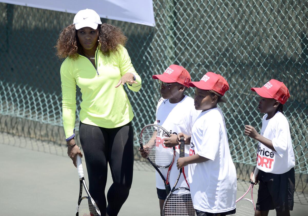 Serena Williams works with children during a clinic at the Arthur Ashe Tennis Centre in the South African township of Soweto on Saturday.