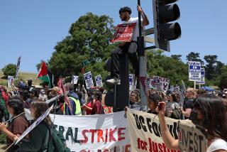 SANTA CRUZ, CALIFORNIA - MAY 20: U.C. Santa Cruz workers who are union members of U.A.W. 4811, which is part of the United Auto Workers, and pro-Palestinian protesters carry signs as they demonstrate in front of the U.C. Santa Cruz campus on May 20, 2024 in Santa Cruz, California. Academic workers at the University of California, Santa Cruz walked off the job Monday morning to strike in protest of the U.C. system’s handling of pro-Palestinian demonstrations. Organizers say the walkout will not last beyond June 30. (Photo by Justin Sullivan/Getty Images)